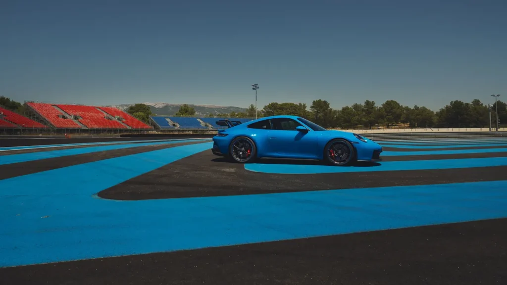 Porsche 911 GT3 taking a sharp turn on a racing circuit