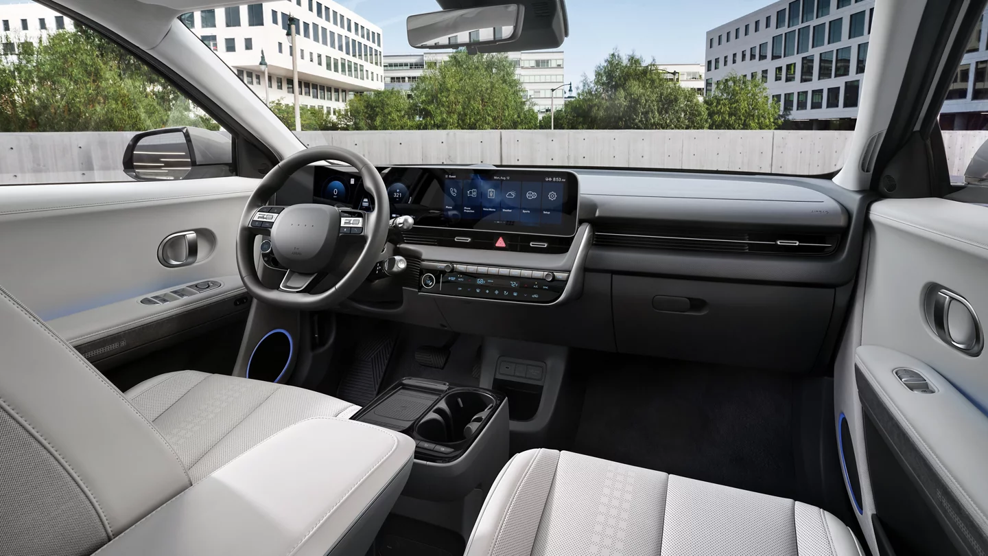 Futuristic interior of the 2025 Hyundai Ioniq 5 with a large curved digital dashboard.